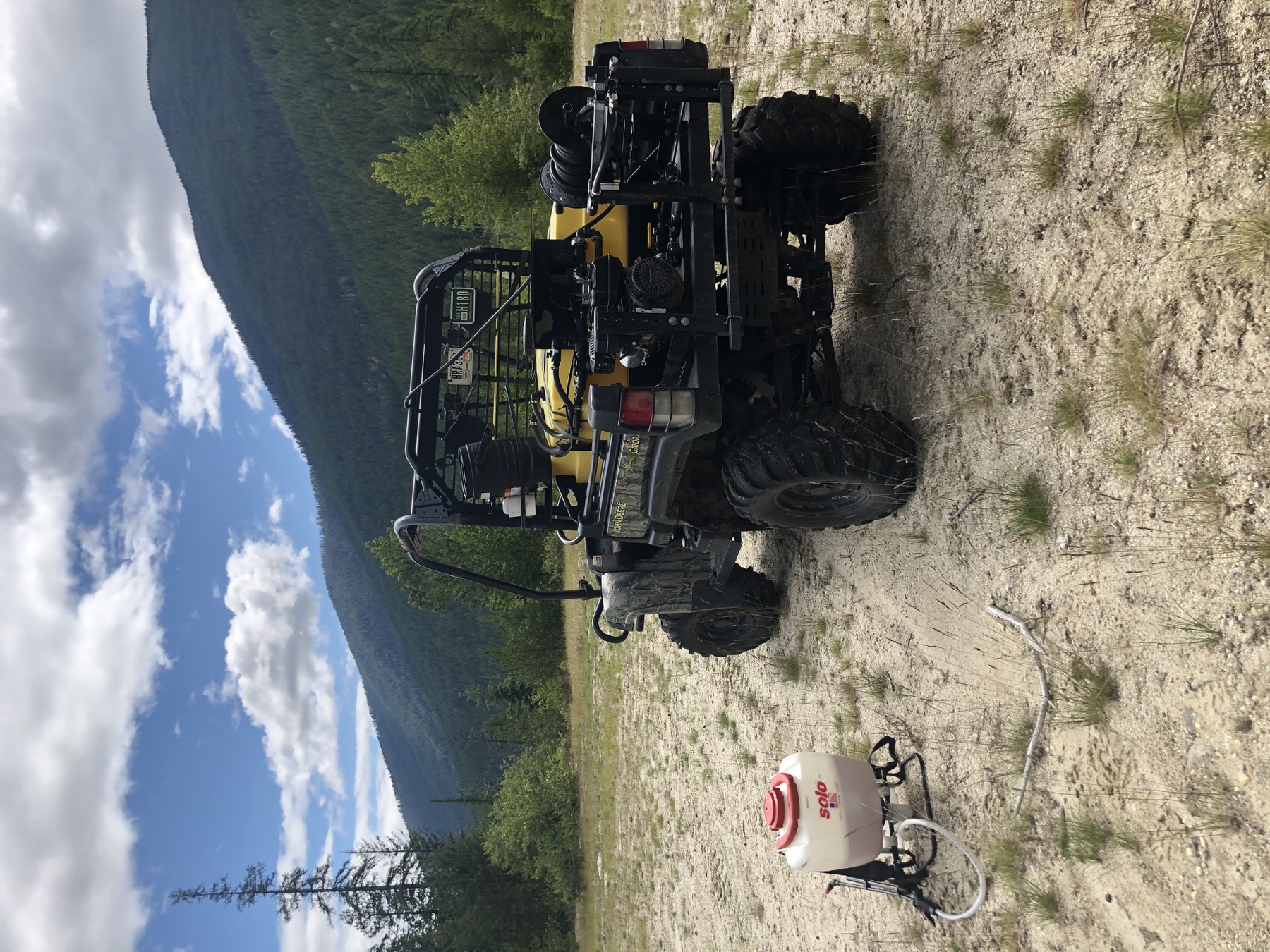 ATV spray rig and field equipment on a rural Northwest property
